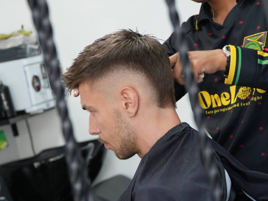 Barber working on a fade at Sae Collective Studio