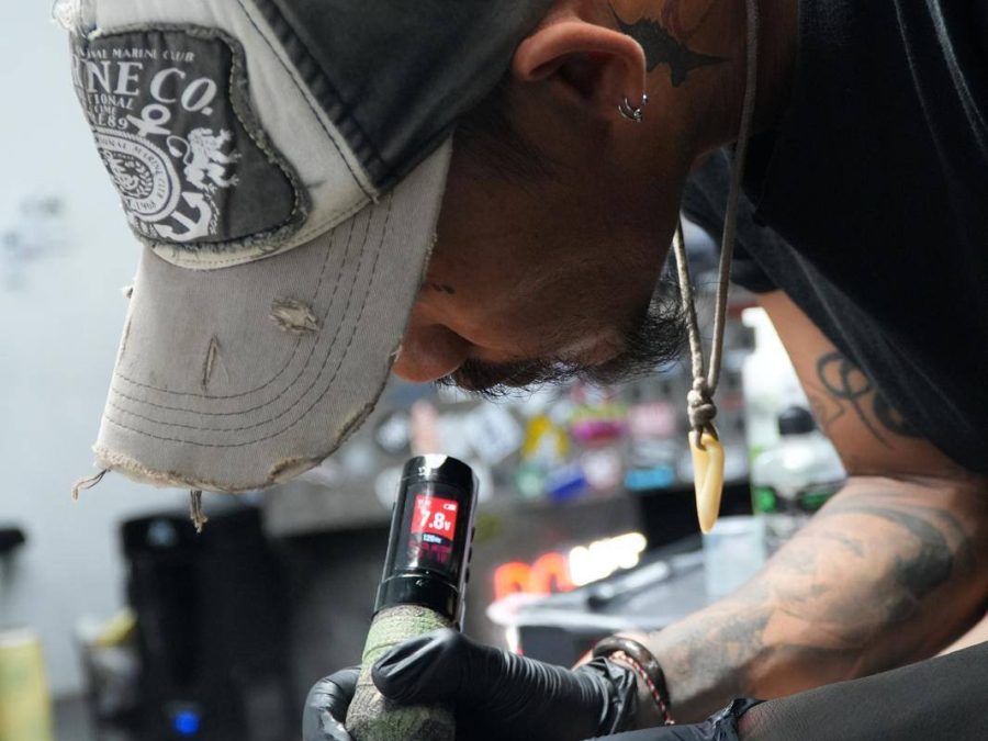 Sae Collective tattoo artist working on a client
